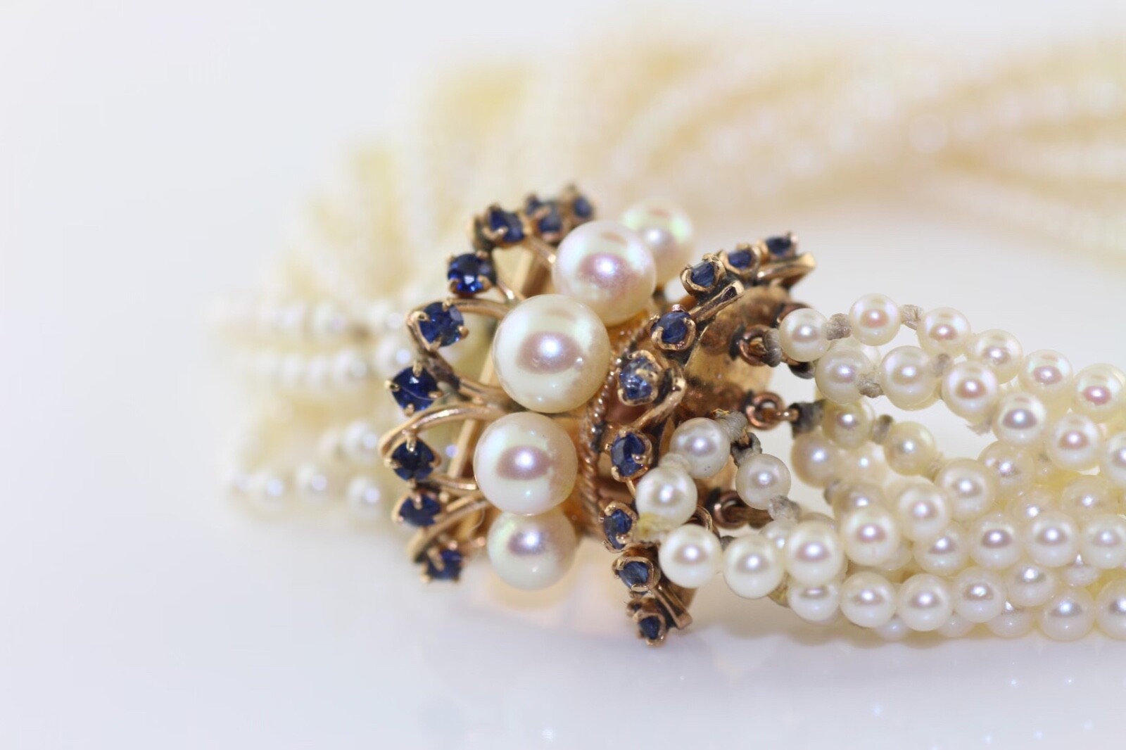 14K yellow gold 12 strand cultured pearl bracelet with Sapphire and Pearl clasp